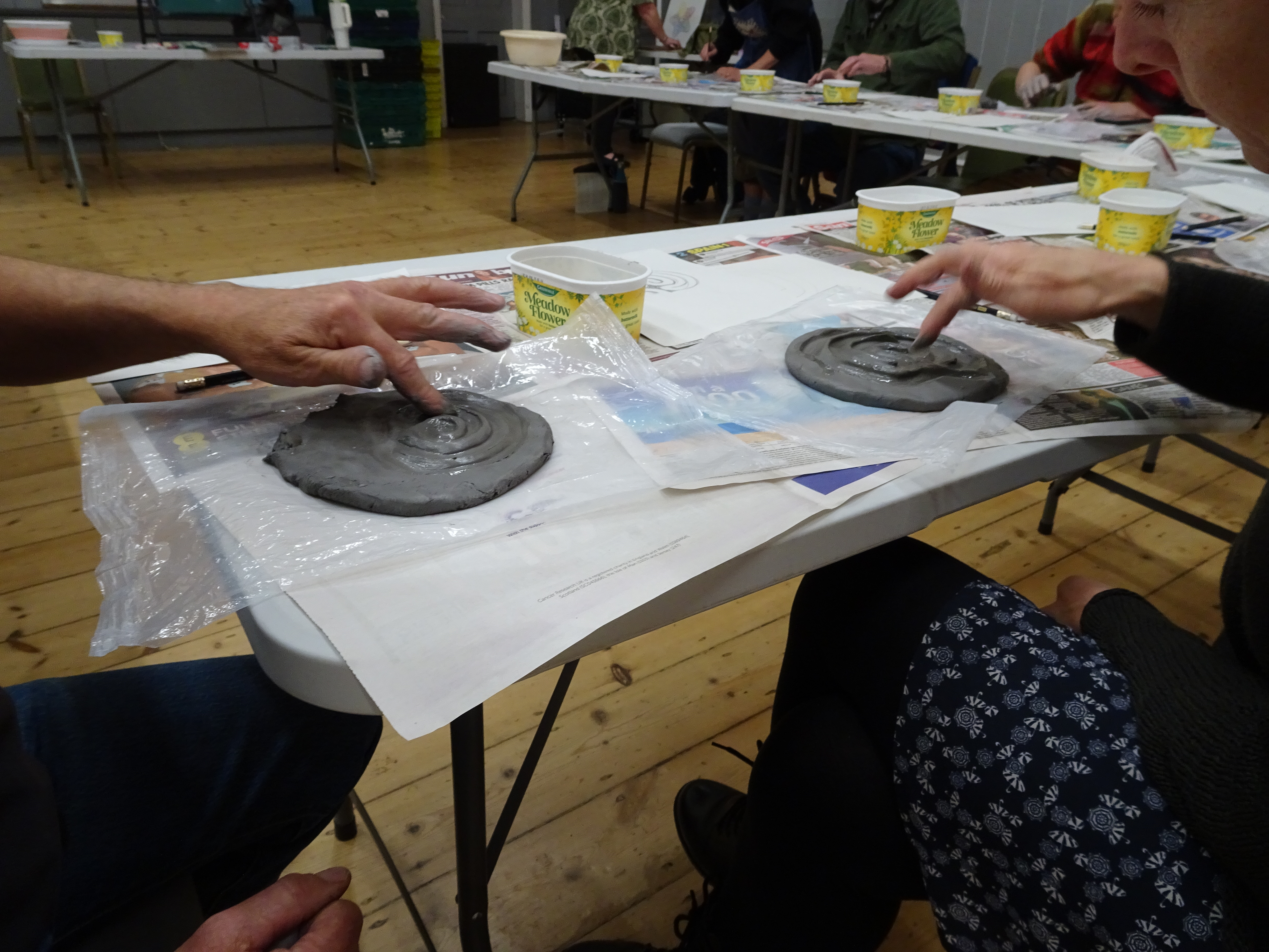 Labyrinth making in progress: two people using their fingers to make the circuits.